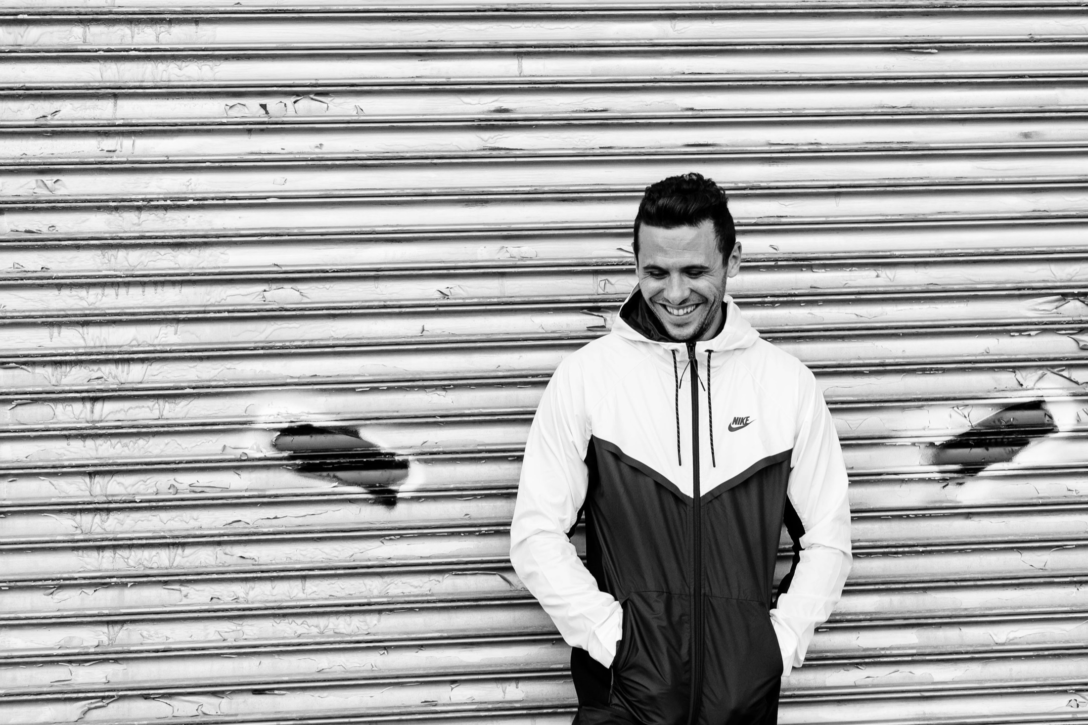 Blair Small smiling in front of a metal shutter