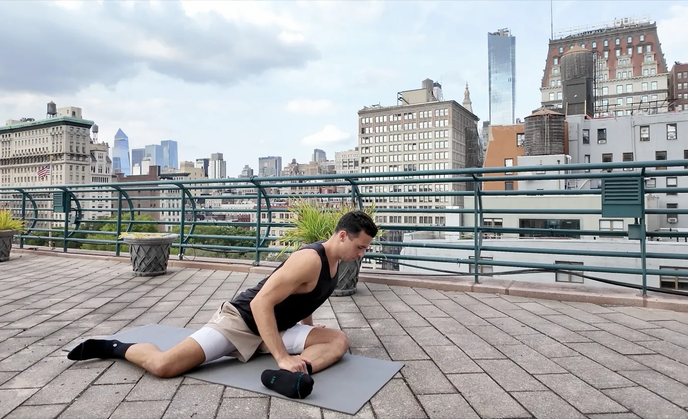 Hip mobility stretch on a rooftop